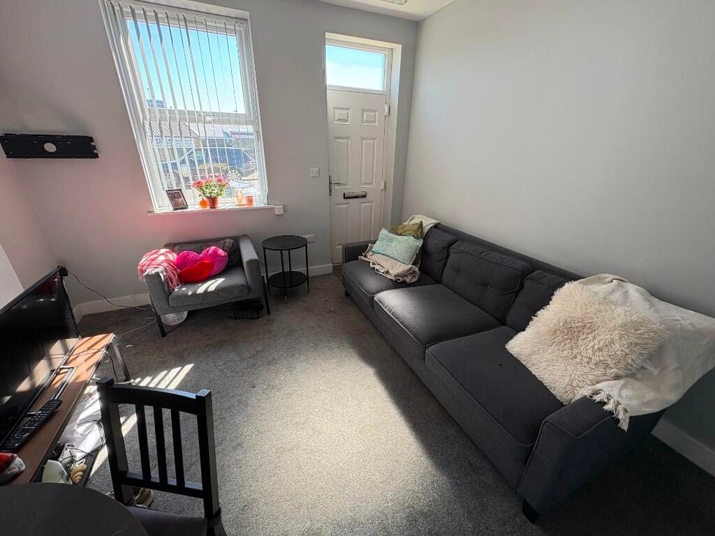 Property photo 3 of 11 Bright And Cozy Living Room Featuring A Comfortabl...