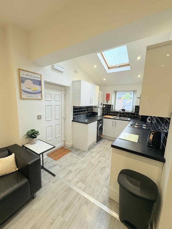 Property photo 1 of 21 Bright Modern Kitchen With White Cabinets, Black c...