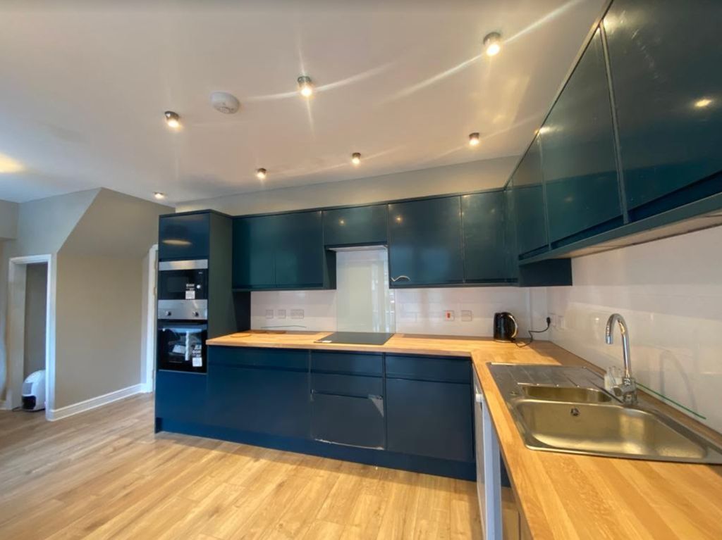 Property photo 2 of 20 A Modern And Clean Kitchen With Blue Cabinets And ...
