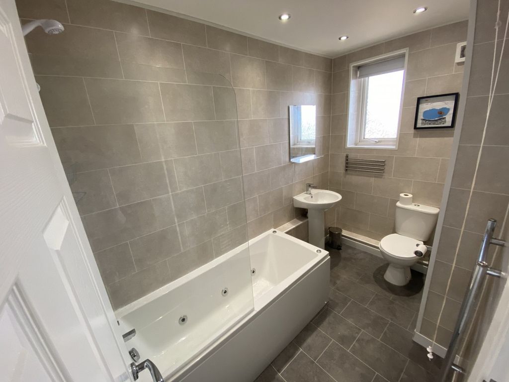 Property photo 1 of 6 A Spacious And Modern Bathroom Featuring A Relaxin...