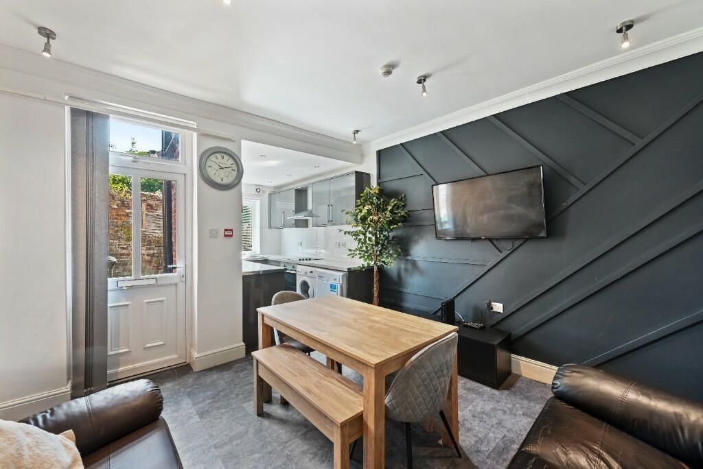 Property photo 3 of 15 Bright And Modern Living Room Featuring A Stylish ...