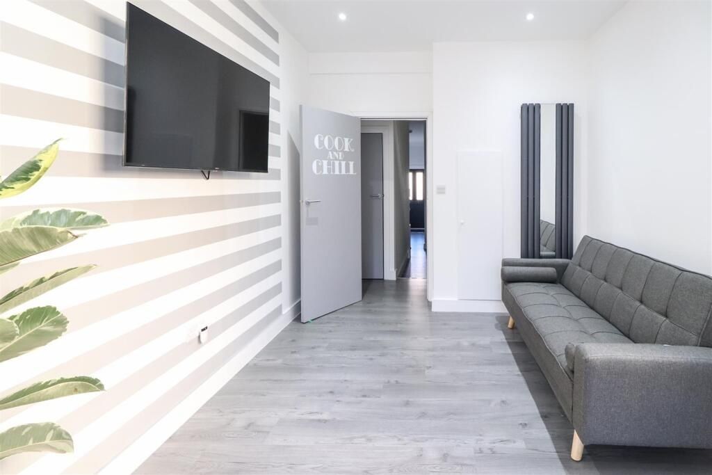 Property photo 3 of 7 Bright, Modern Living Area With A Wall-Mounted TV,...