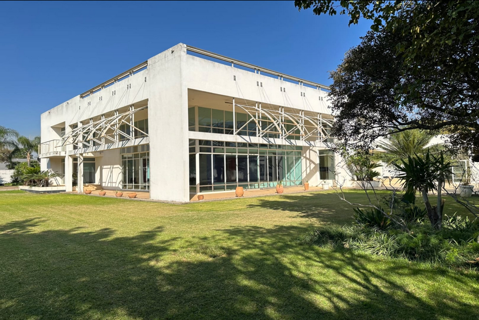 Property photo 2 of 24 Modern White Office Building With Glass Walls And Decorative Metal Sunshades, Set In A Well-Kept Lawn Under Blue Sky