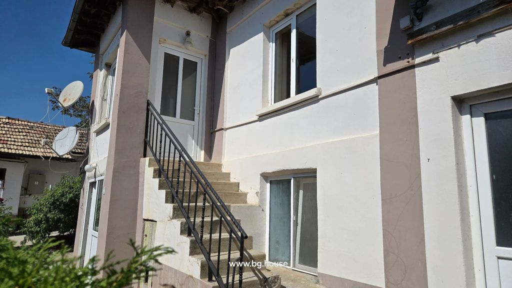 Property photo 2 of 100 White Building Corner With Window, Door, And Black Metal Railing On Concrete Stairs Under Clear Sky.