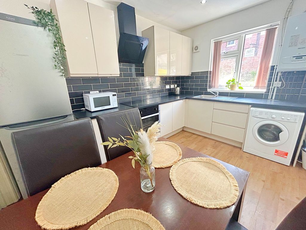 Property photo 1 of 8 Bright And Modern Kitchen Featuring Cream Cabinetr...