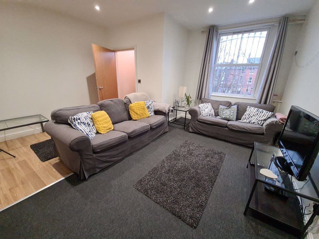 Property photo 3 of 10 A Spacious, Well-Lit Living Room Featuring Comfort...