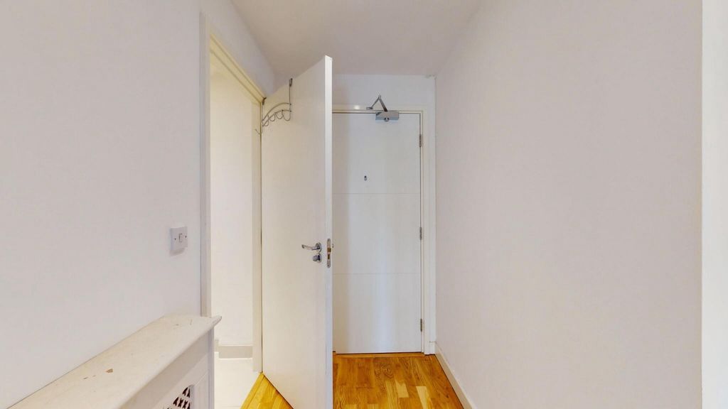 Property photo 1 of 14 Bright And Clean Hallway Featuring Polished Wooden...