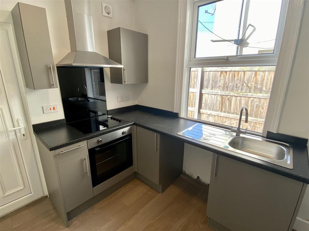 Property photo 2 of 6 Modern Kitchen With Sleek Grey Units And Window...