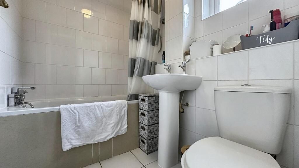 Property photo 3 of 6 A Clean And Bright Bathroom Featuring A Bathtub Wi...