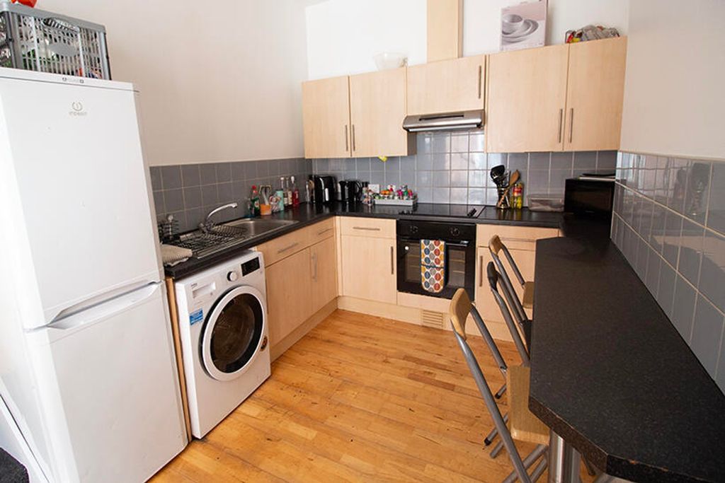 Property photo 2 of 4 Stylish Kitchen Featuring Modern Appliances, Ample...