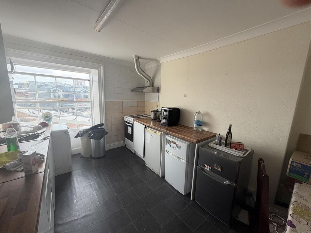 Property photo 3 of 5 Bright Kitchen With Ample Natural Light And Storag...