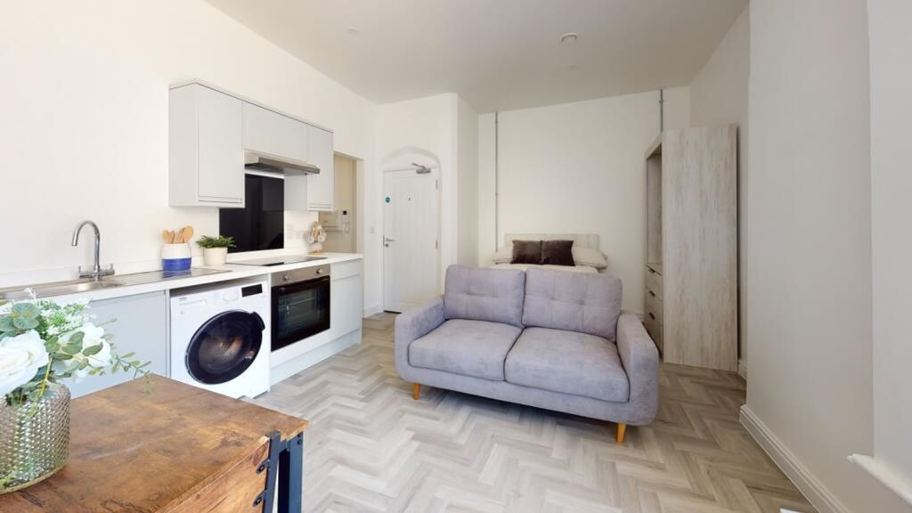 Property photo 2 of 4 A Spacious And Modern Living Room Featuring A Cozy...