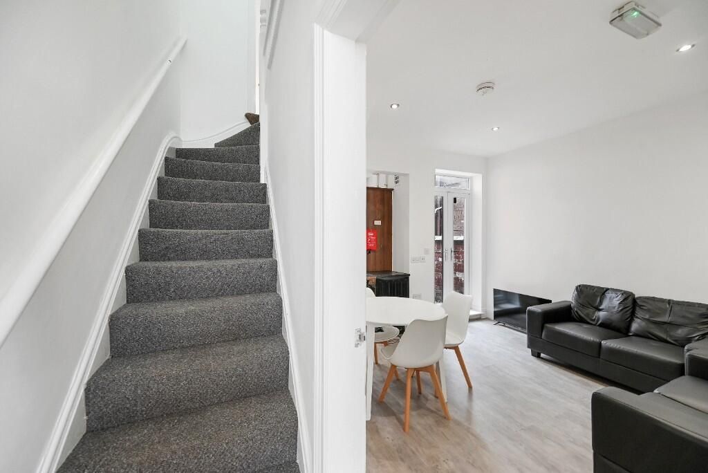 Property photo 3 of 10 A Modern Living Room Featuring A Comfortable Black...