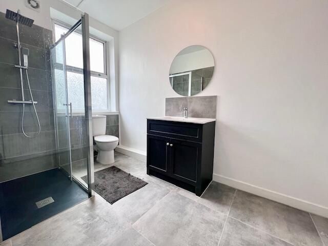 Property photo 3 of 9 Bright And Modern Bathroom Featuring A Spacious Wa...