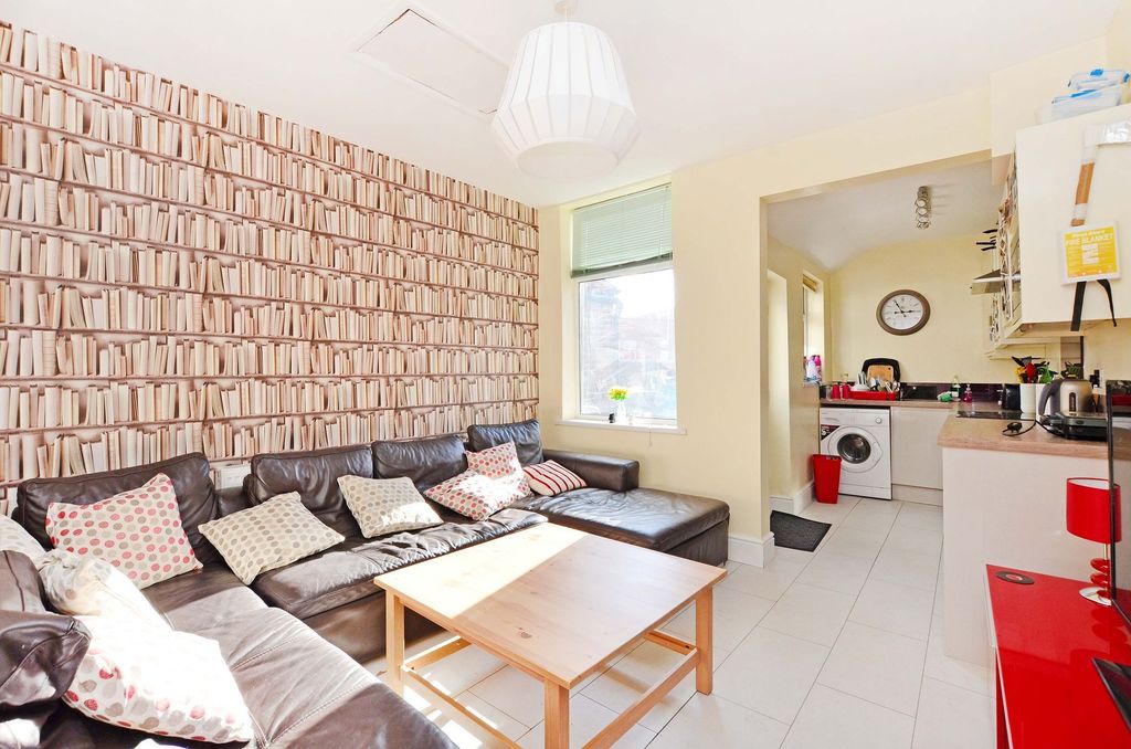 Property photo 1 of 6 Bright And Inviting Living Room Featuring A Large ...