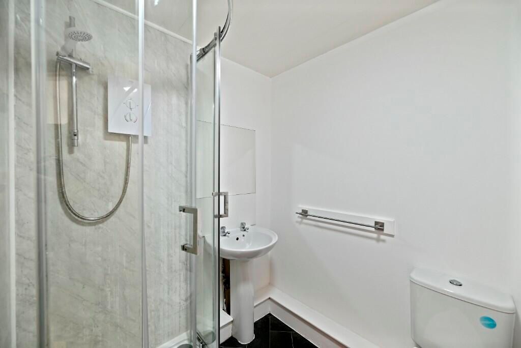 Property photo 3 of 12 A Clean, Modern Bathroom Featuring A Glass-Enclose...