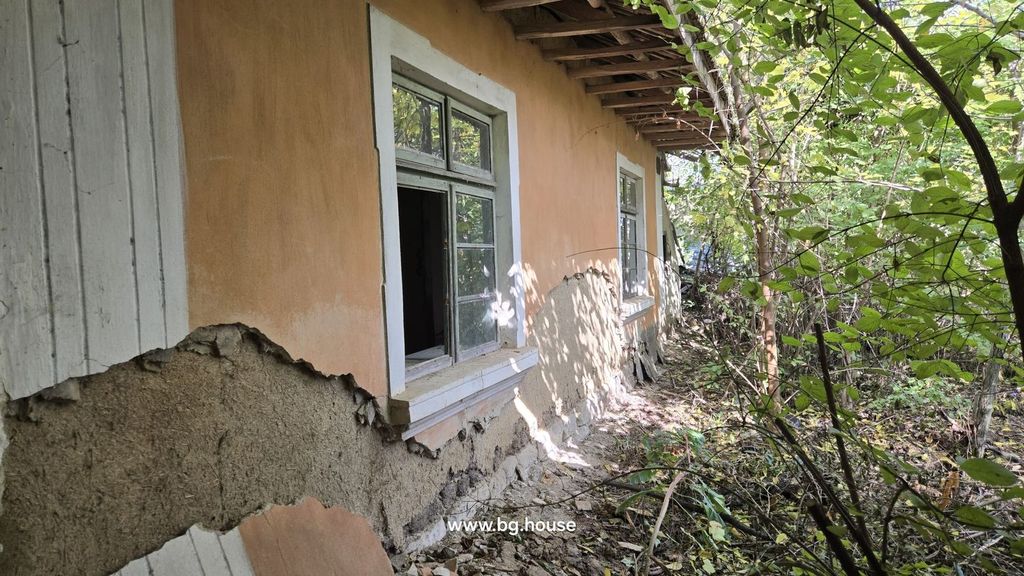 Property photo 1 of 32 View Of The House Exterior Showing Damaged Plaster And Green-Framed Windows With Surrounding Trees And Bushes.