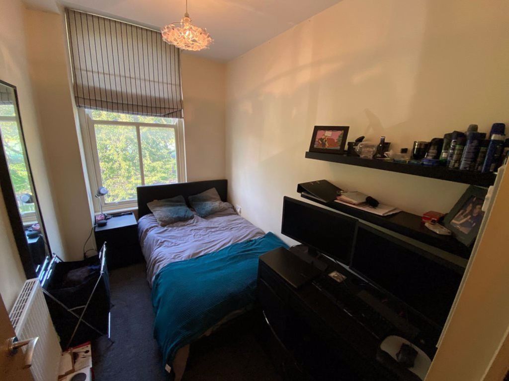 Property photo 3 of 19 A Cozy Bedroom Featuring A Double Bed, A Desk With...
