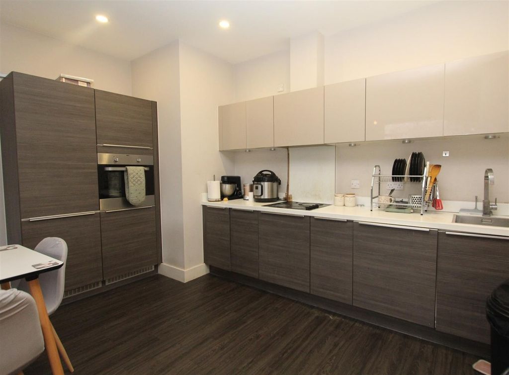 Property photo 3 of 9 Modern Kitchen With Sleek Cabinetry And Storage...