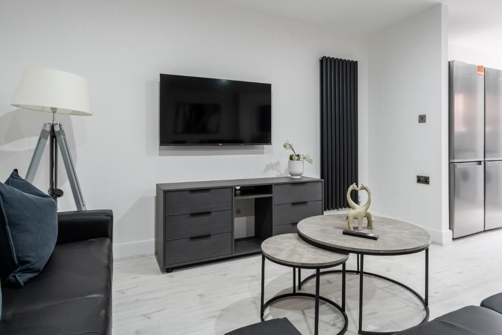 Property photo 1 of 12 A Modern And Stylish Living Room Featuring A Sleek...