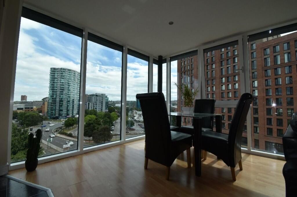 Property photo 2 of 12 Bright And Modern Living Room Featuring Floor-To-c...