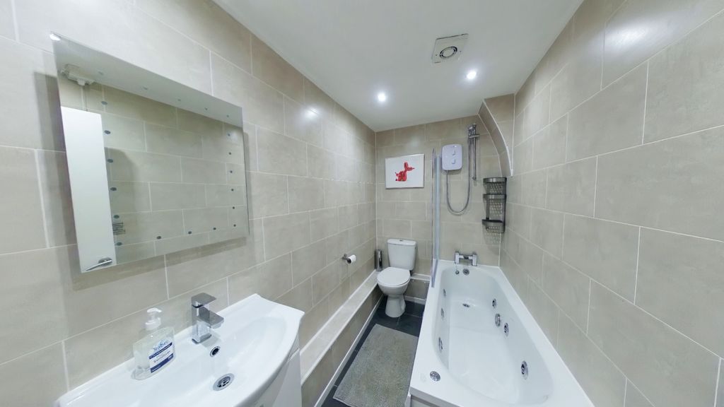 Property photo 2 of 8 A Spacious And Well-Lit Large Bathroom Featuring A...