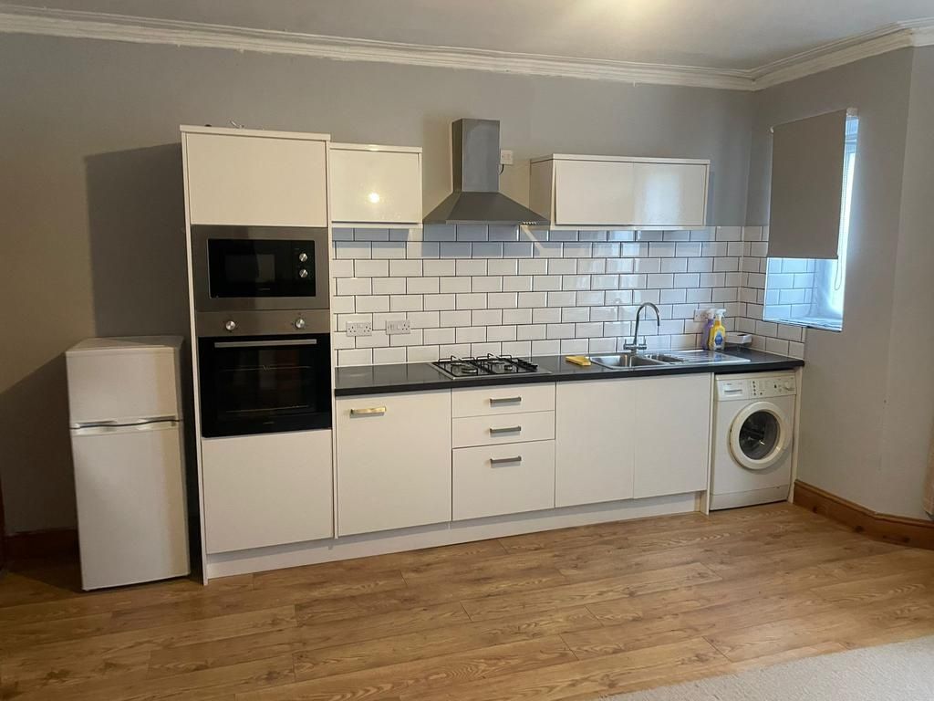 Property photo 3 of 8 Modern Fitted Kitchen With White Cabinetry, Black ...