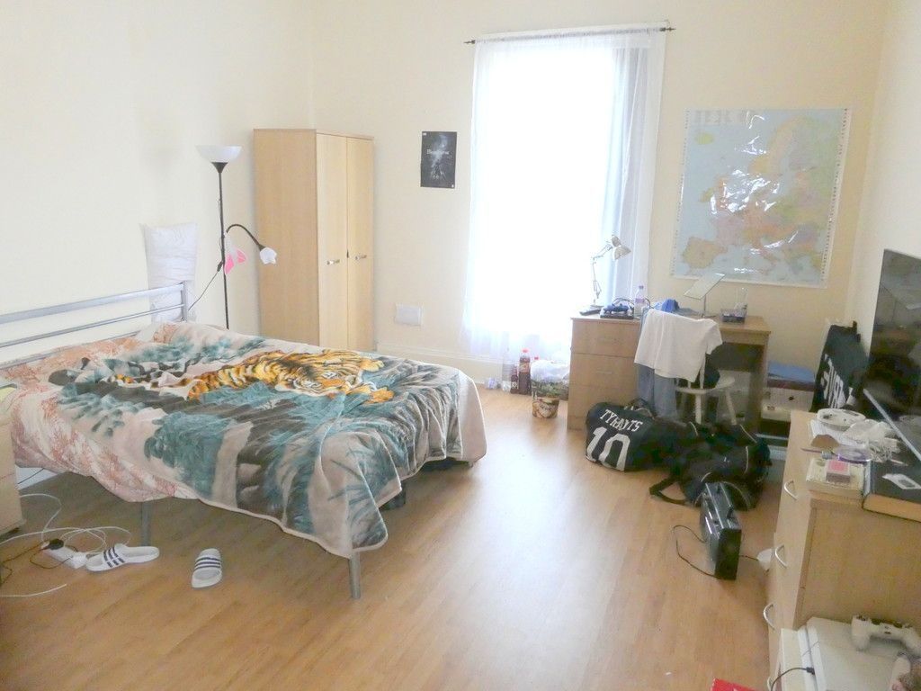 Property photo 2 of 7 A Spacious And Well-Lit Bedroom Featuring A Large ...