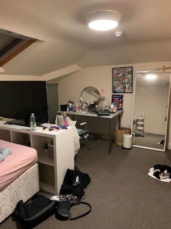 Property photo 1 of 24 A Cozy, Well-Lit Bedroom Featuring A Comfortable B...