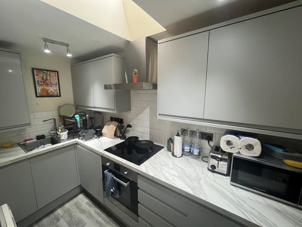 Property photo 1 of 8 Bright And Modern Kitchen Featuring Sleek Grey Cab...