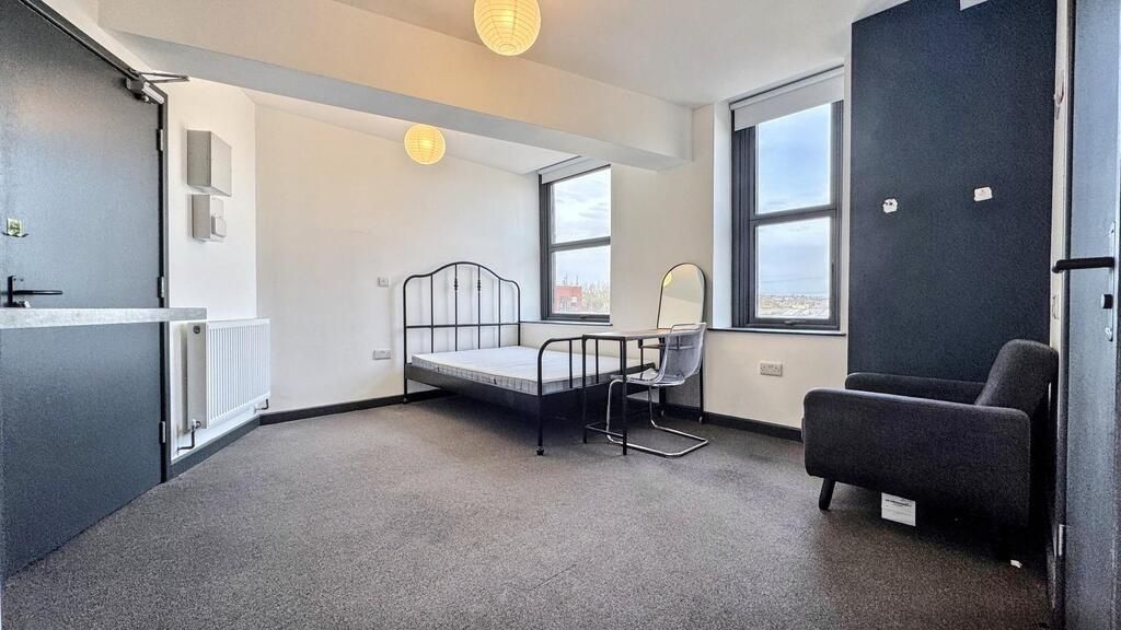 Property photo 1 of 4 A Spacious, Well-Lit Living Room Featuring Large W...