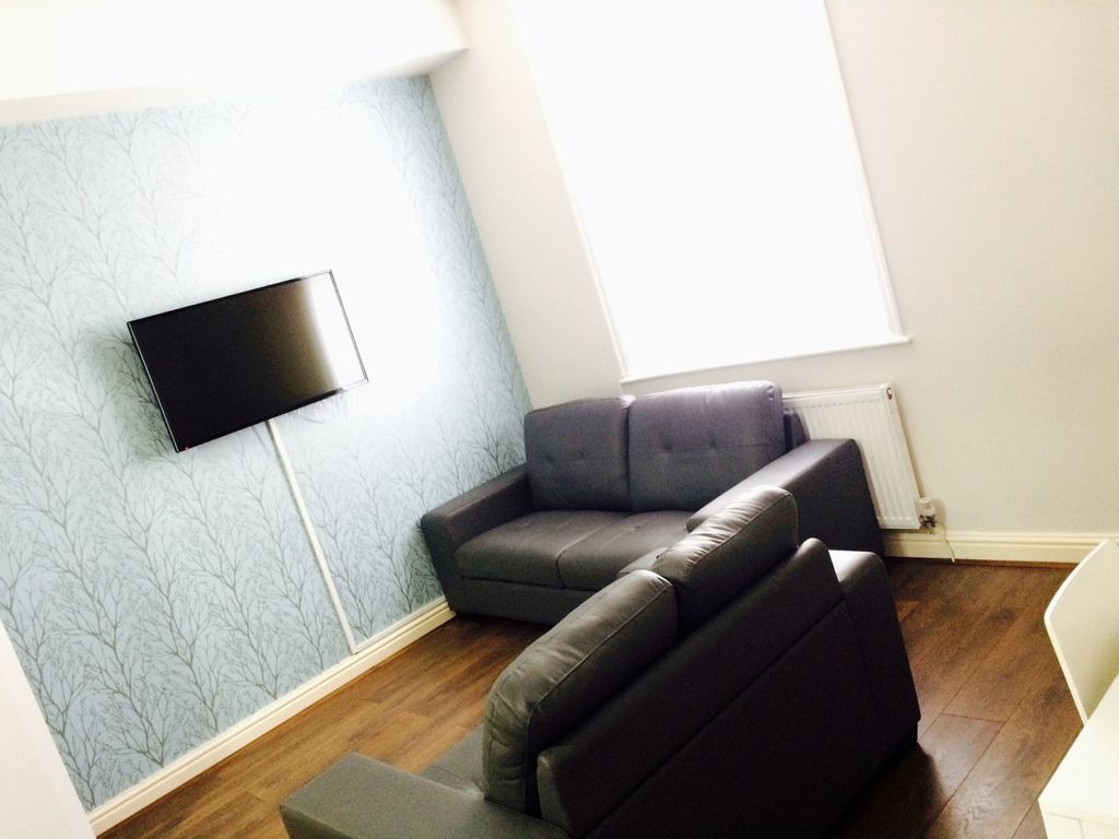 Property photo 2 of 12 A Bright And Inviting Living Room Featuring Modern...