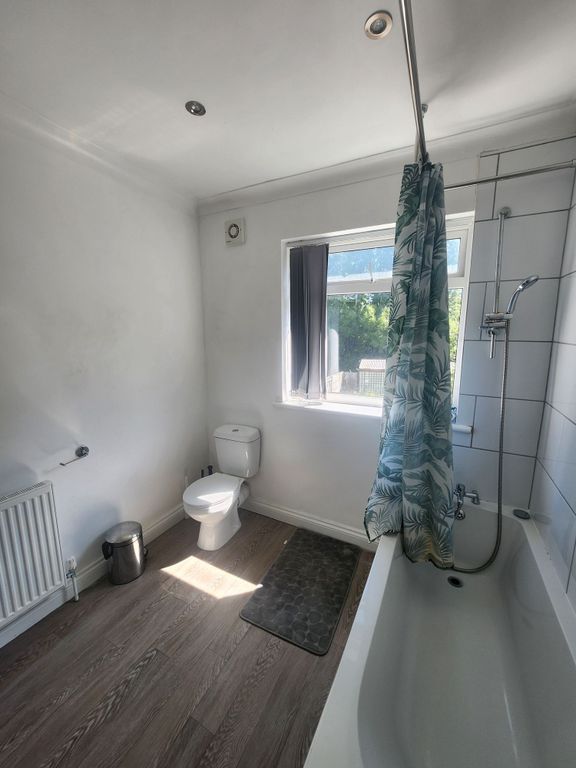 Property photo 3 of 17 Bright, Wellâ€‘Kept Bathroom With A Bathtub And Show...