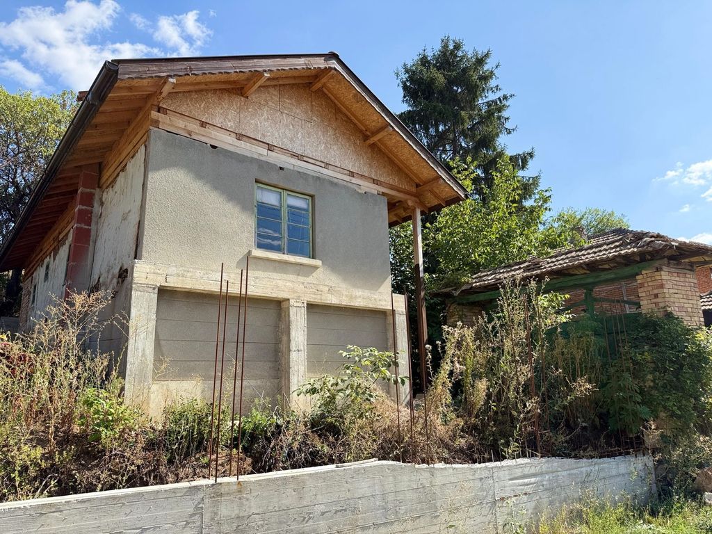 Property photo 1 of 52 Exterior View Of An Old Bulgarian House Showing New Roof Construction And Chimney Against A Clear Sky.