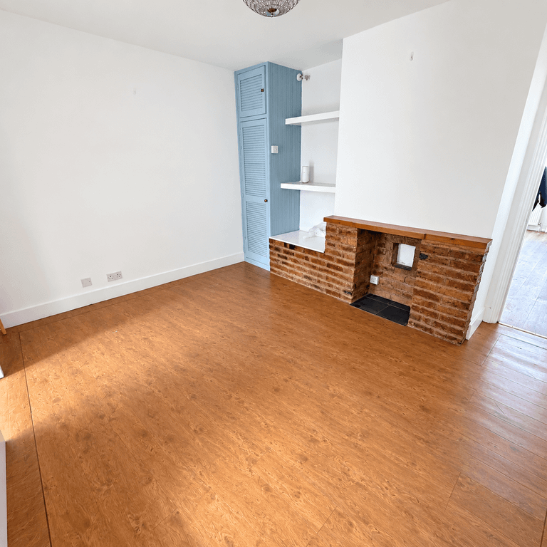 Property photo 3 of 8 Bright Minimalist Room With Brick Fireplace