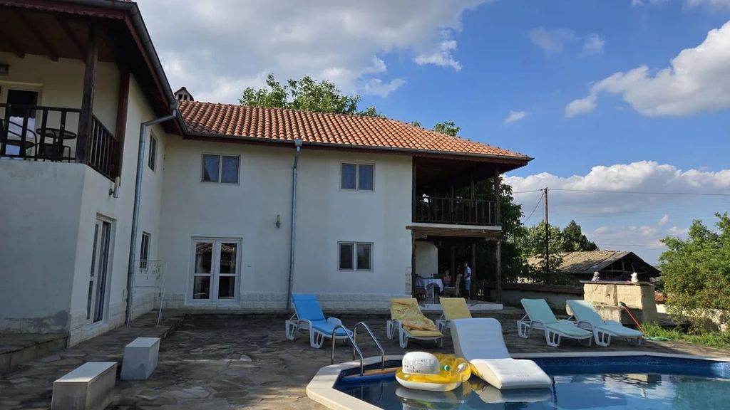 Property photo 1 of 60 View Of The White Two-Storey House With A Tiled Roof And A Swimming Pool Surrounded By Sun Loungers On A Stone Patio.