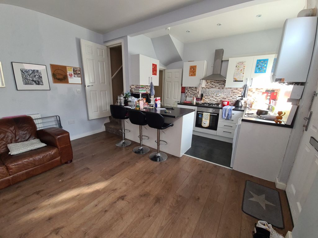 Property photo 1 of 7 A Modern, Open-Plan Kitchen Featuring A Wooden Flo...