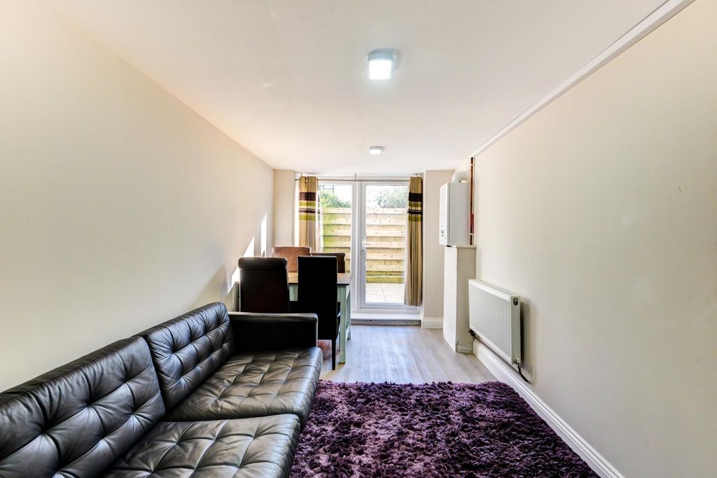 Property photo 3 of 14 Contemporary Living Room With A Black Leather Sofa...