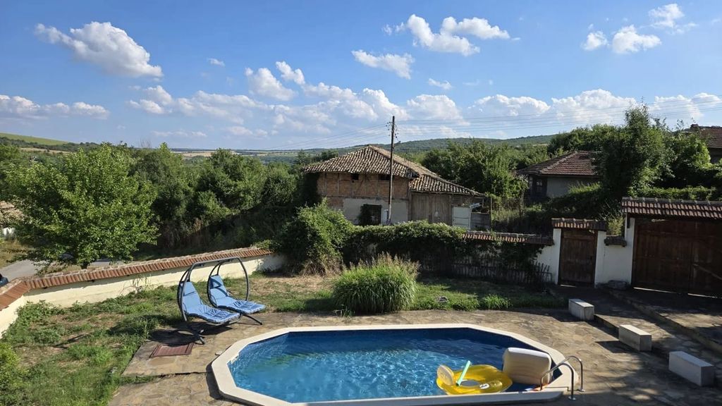 Property photo 2 of 60 Outdoor Swimming Pool With Clear Blue Water And Two Blue Double Sun Loungers Set On Stone Paving Near Garden Greenery.