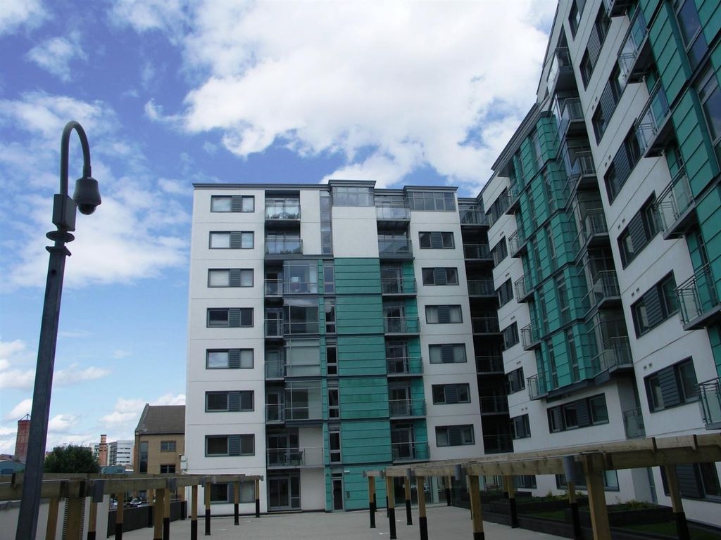 Property photo 1 of 6 Modern Apartment Exterior With Bright Blue Sky...