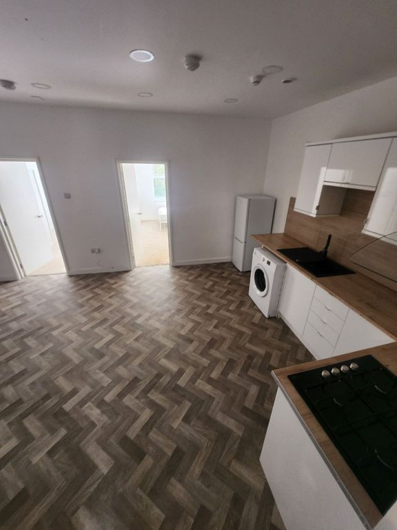 Property photo 3 of 7 A Modern Kitchen Featuring A Stylish Herringbone F...