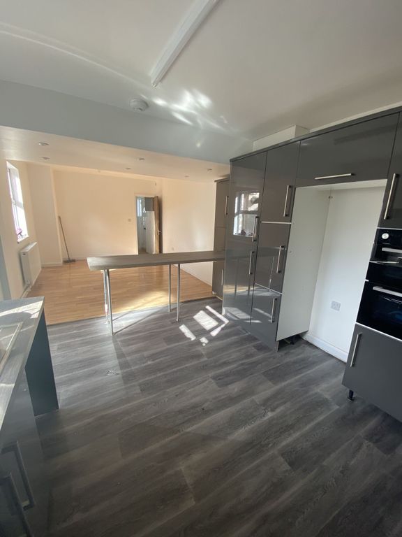 Property photo 1 of 6 Modern Kitchen With Sleek Grey Cabinetry, Ample Na...
