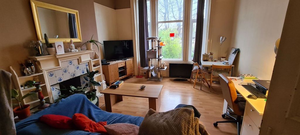 Property photo 3 of 9 A Well-Lit, Inviting Living Room Featuring Comfort...