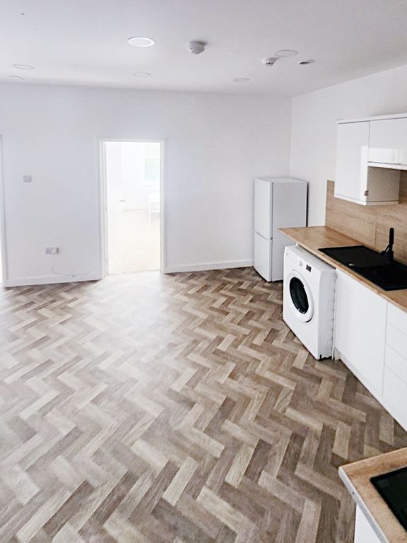 Property photo 1 of 8 Bright Open-Plan Kitchen Area With Modern White Ca...