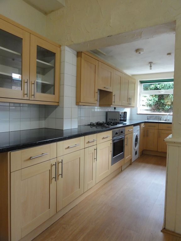 Property photo 2 of 11 Bright Galley Kitchen With Light Wood Cabinets, Bl...