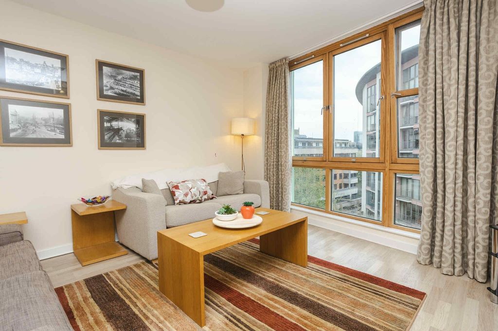 Property photo 2 of 28 A Bright And Inviting Living Room Featuring Large ...