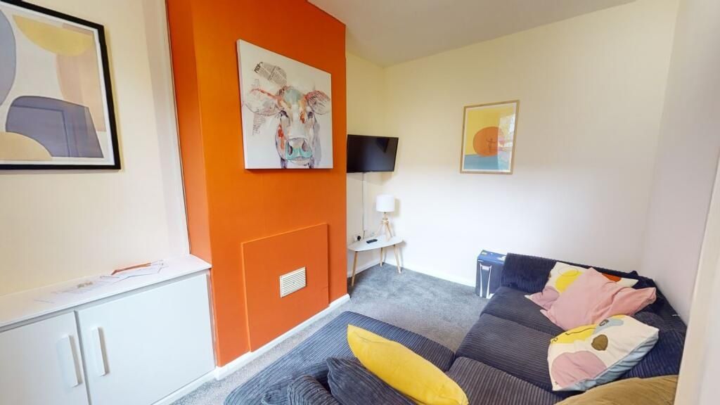 Property photo 1 of 10 A Cozy Living Room With A Stylish Orange Fireplace...