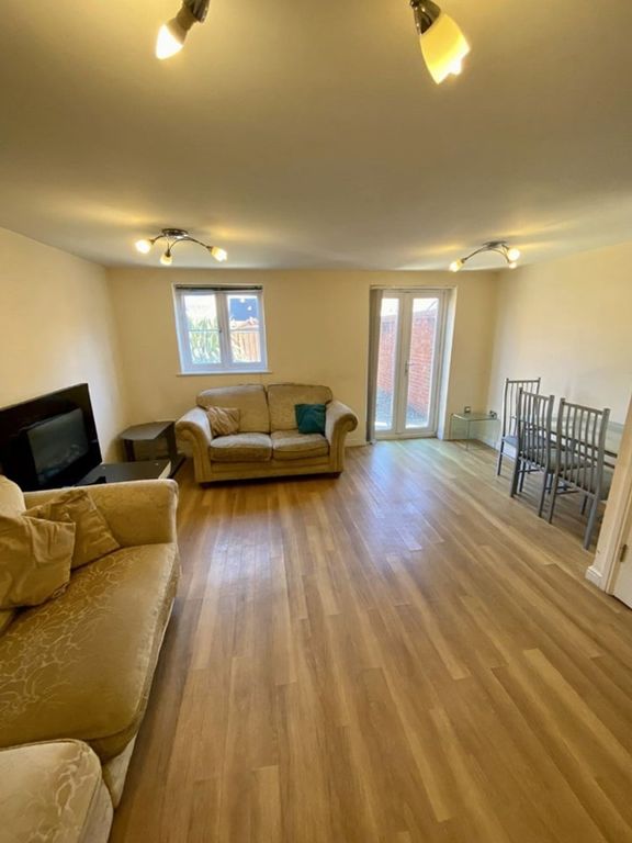 Property photo 2 of 11 Spacious Living Room Featuring Abundant Natural li...