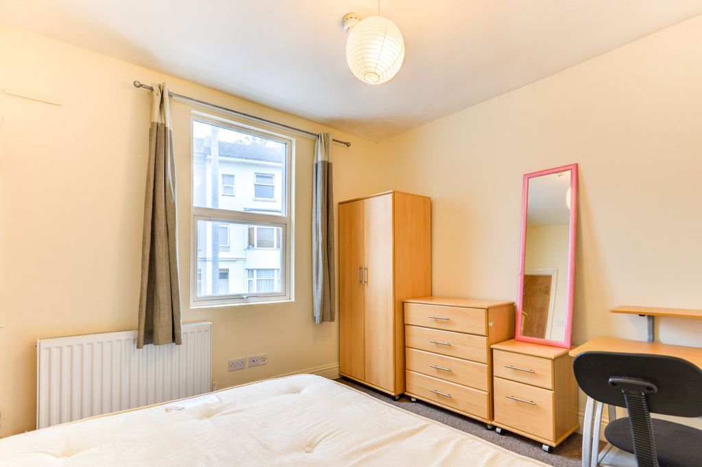 Property photo 3 of 19 A Well-Lit, Tidy Bedroom Featuring A Large Window ...