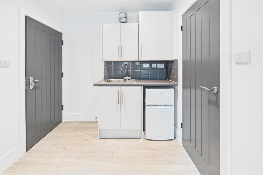 Property photo 3 of 5 Bright Compact Kitchenette With White Cabinetry, T...